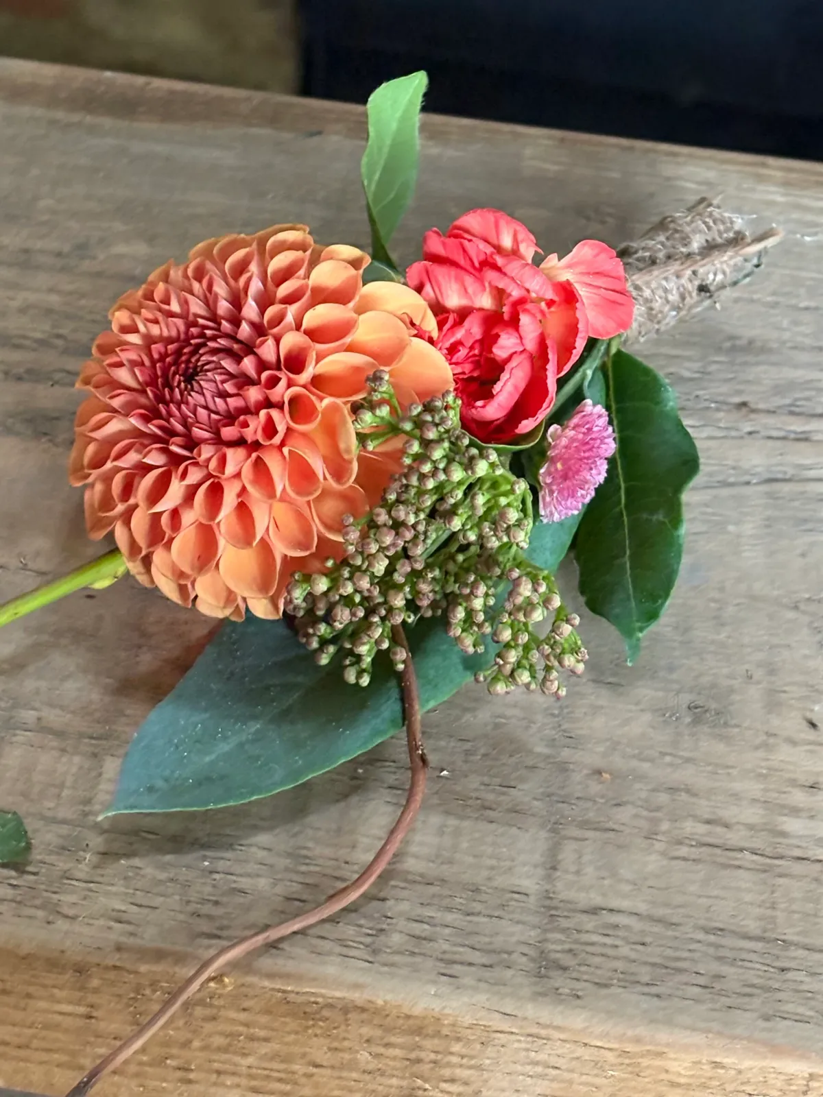 Orange dahlia buttonhole with carnation and hessian wrap