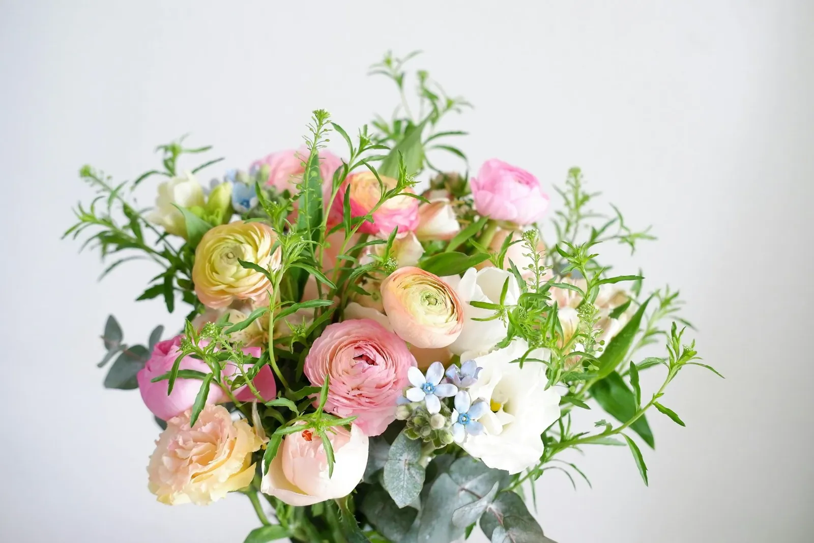 Pastel bouquet of ranunculus, lisianthus and eucalyptus