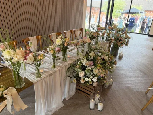Wedding top table dressed with meadow flowers and candles
